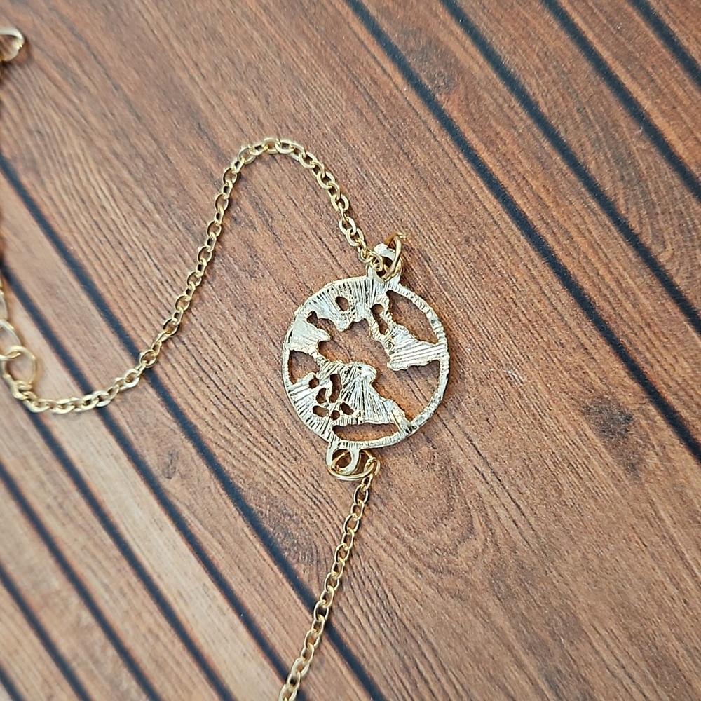 Goldtone bracelet globe world cut out design NWOT